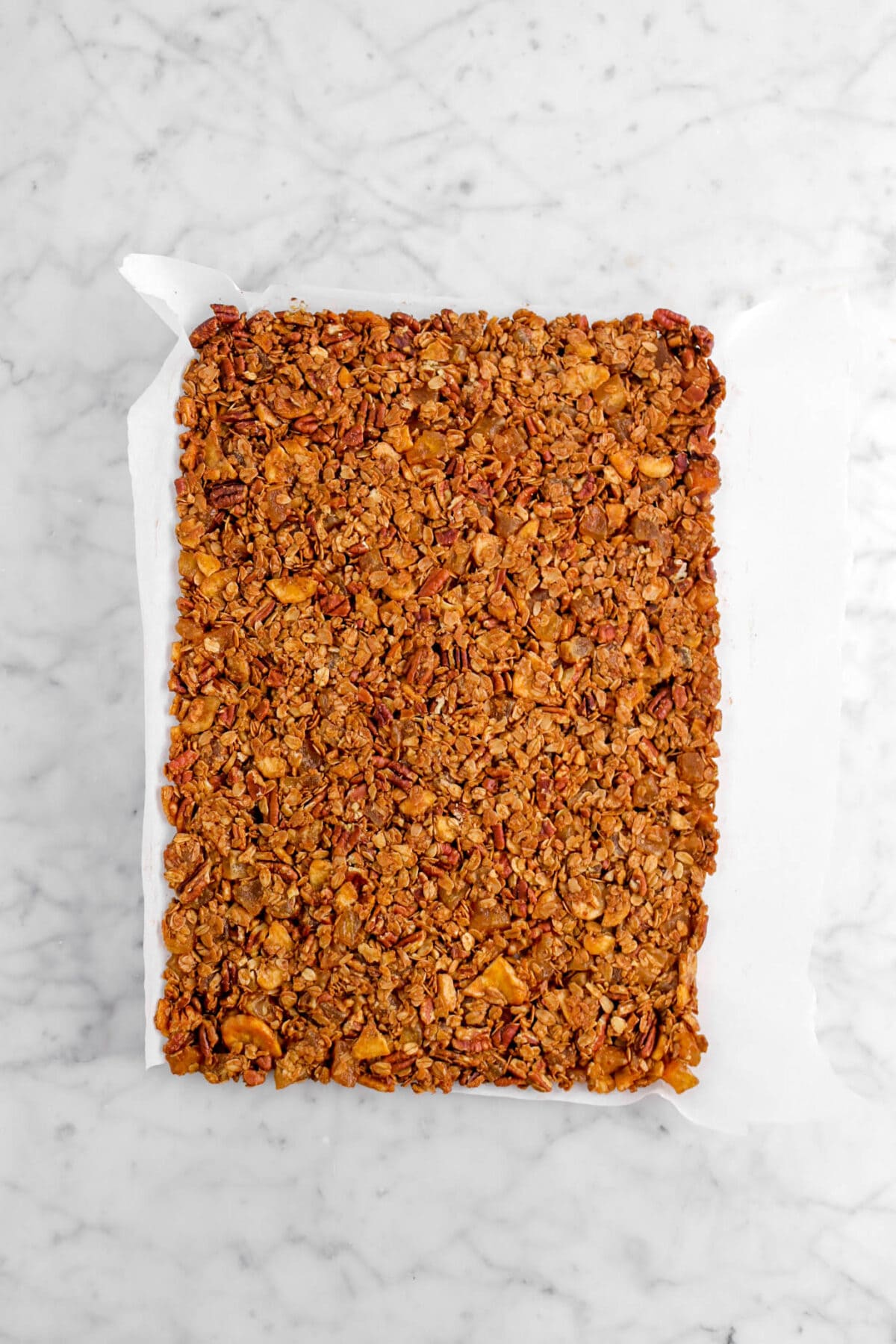baked granola on parchment paper