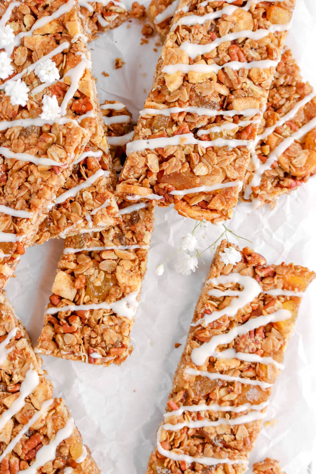 close up of hummingbird granola bars with flowers on parchment paper