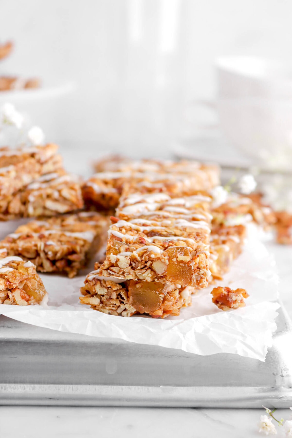 two stacked granola bars on upside down sheet pan with more granola bars behind