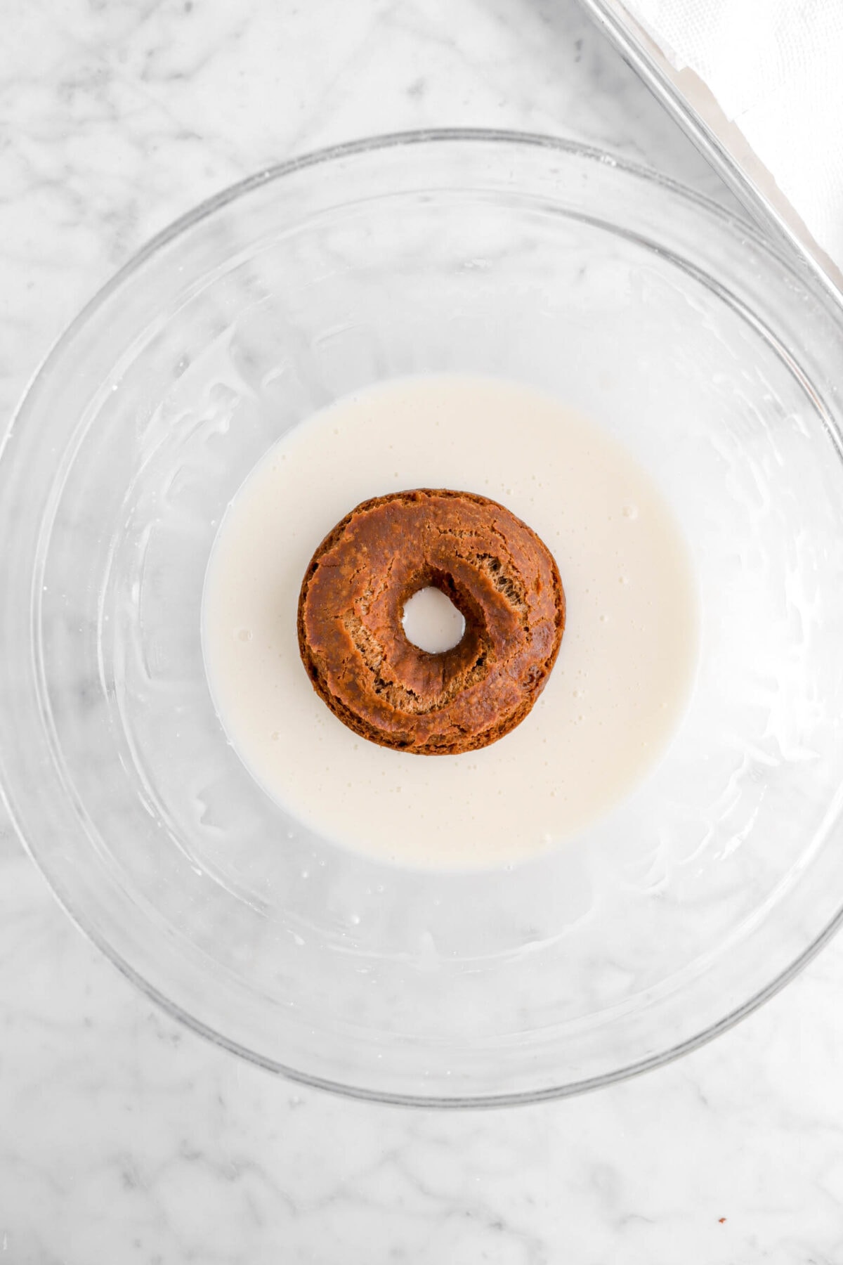 doughnut in bowl of glaze