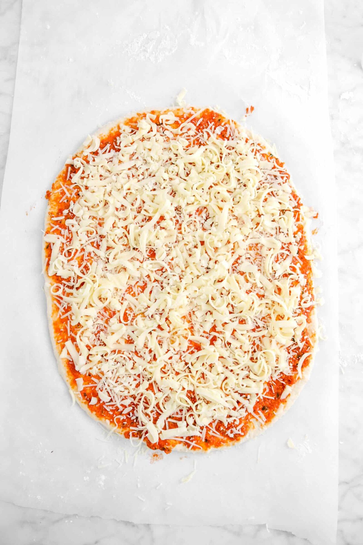 grated mozzarella added on top of parmesan