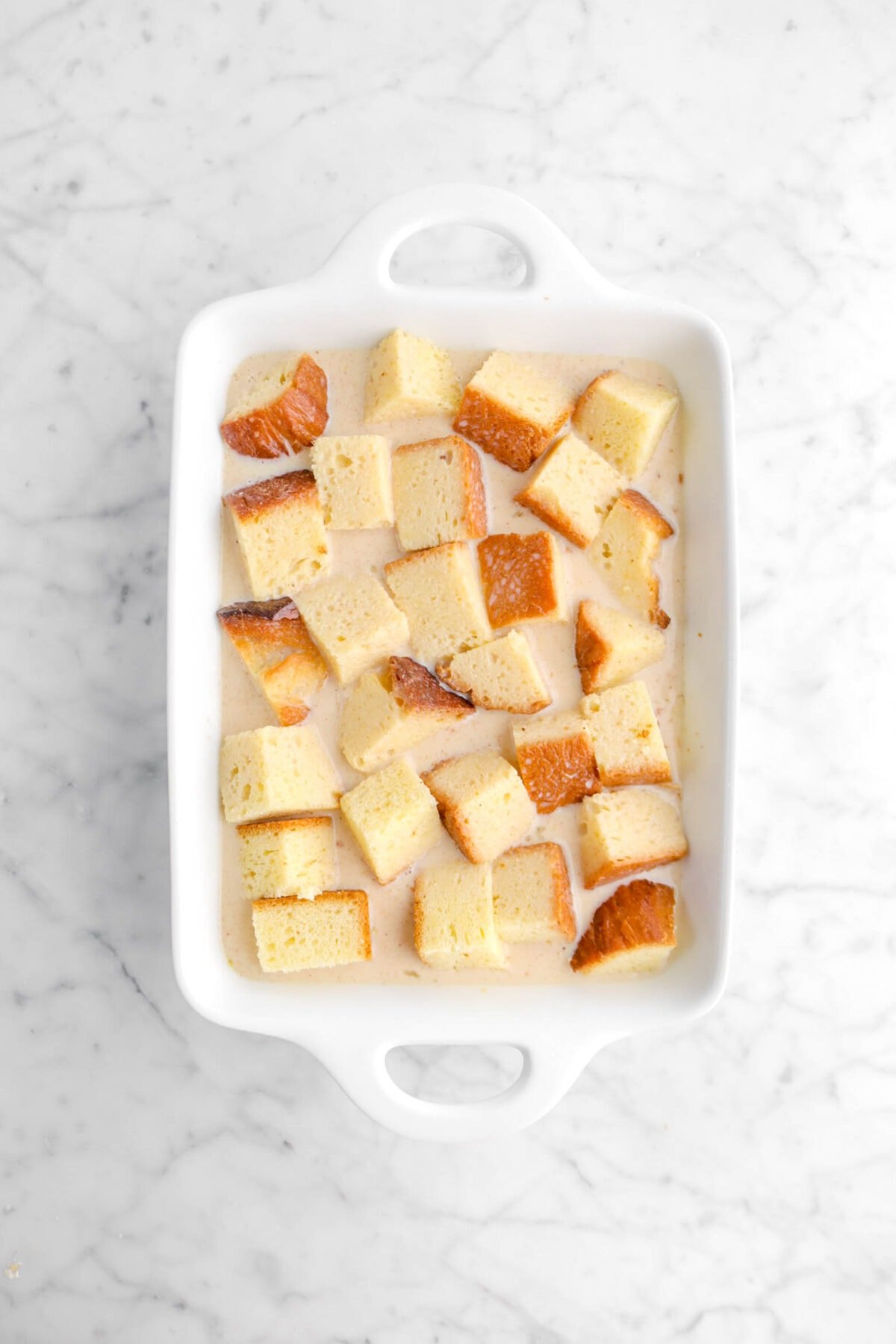 custard poured over cubed bread