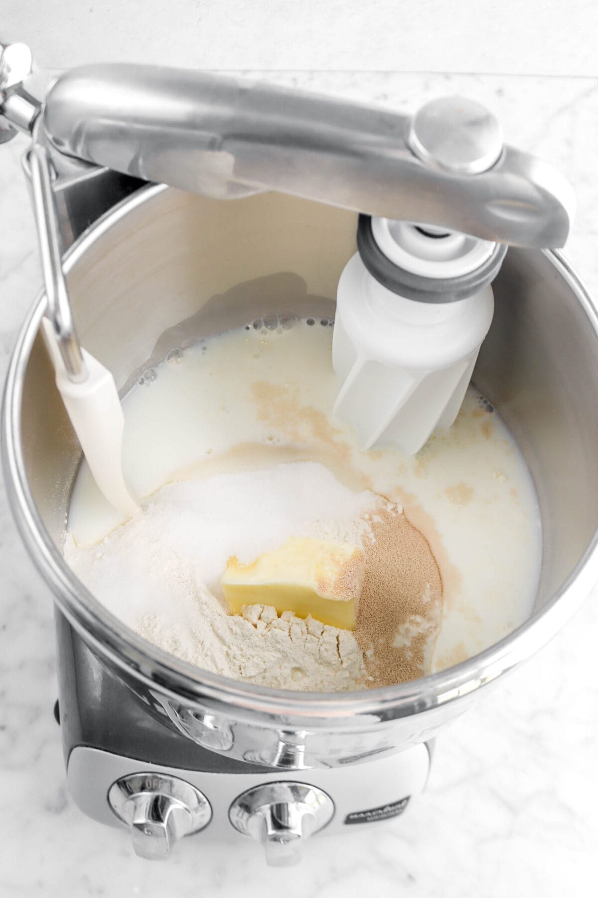 milk, butter, sugar, yeast, and flour in mixer bowl