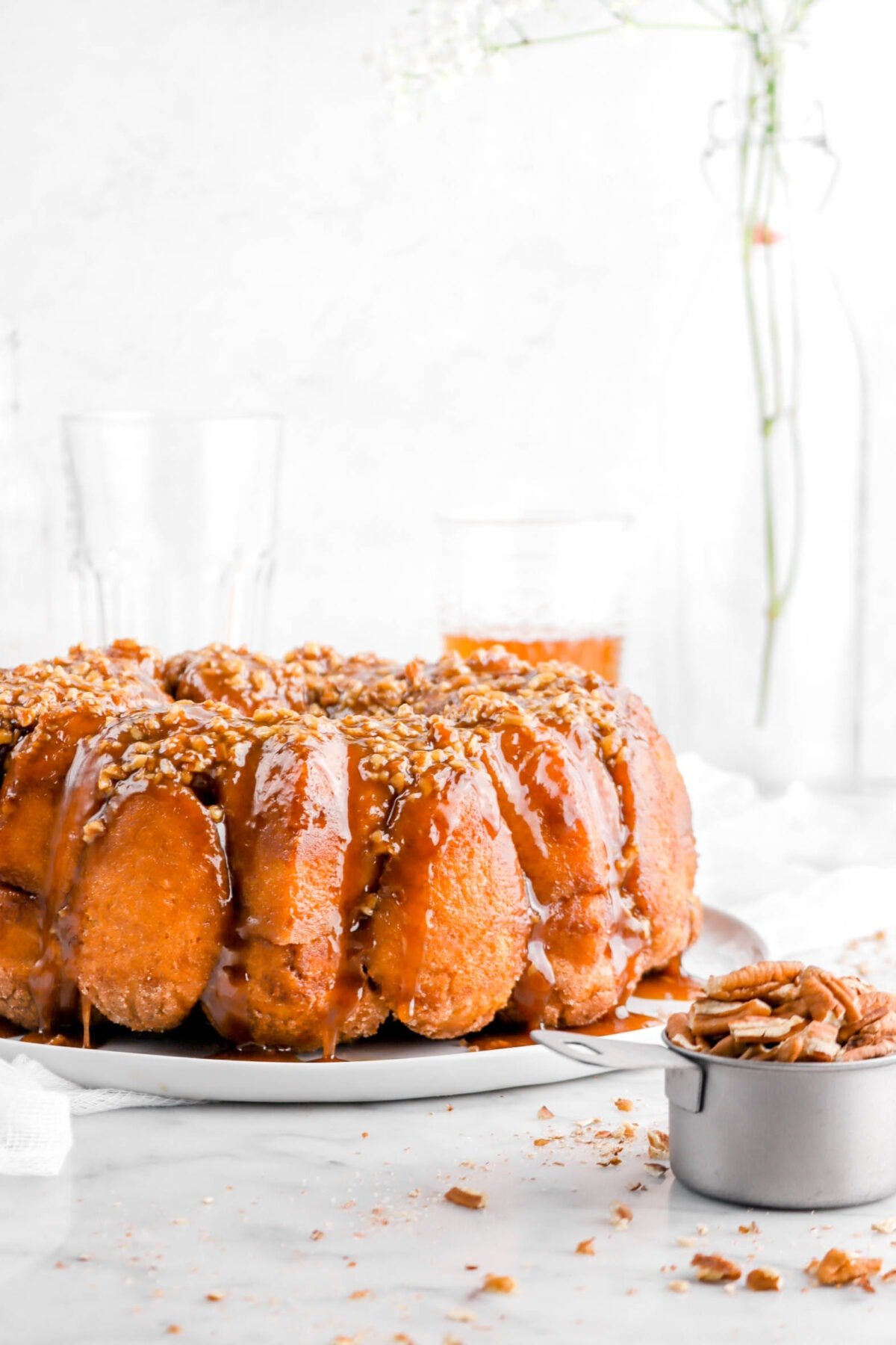close up of monkey bread with flowers behind