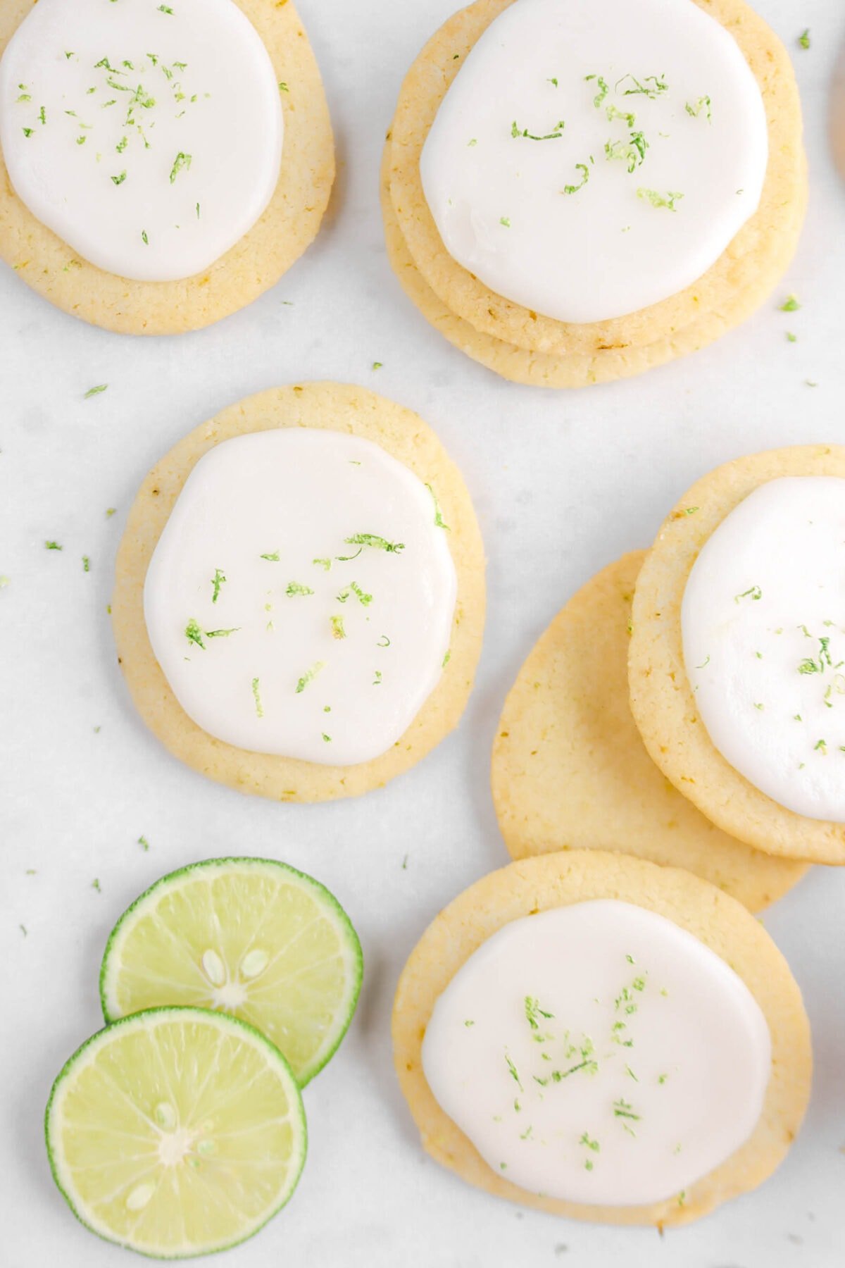 overhead shot of six key lime cookies with two slices of lime beside