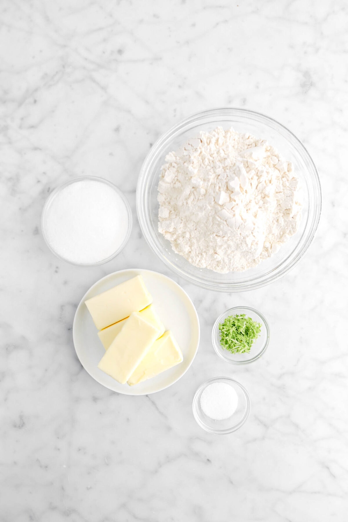 flour, sugar, butter, lime zest, and salt on marble counter