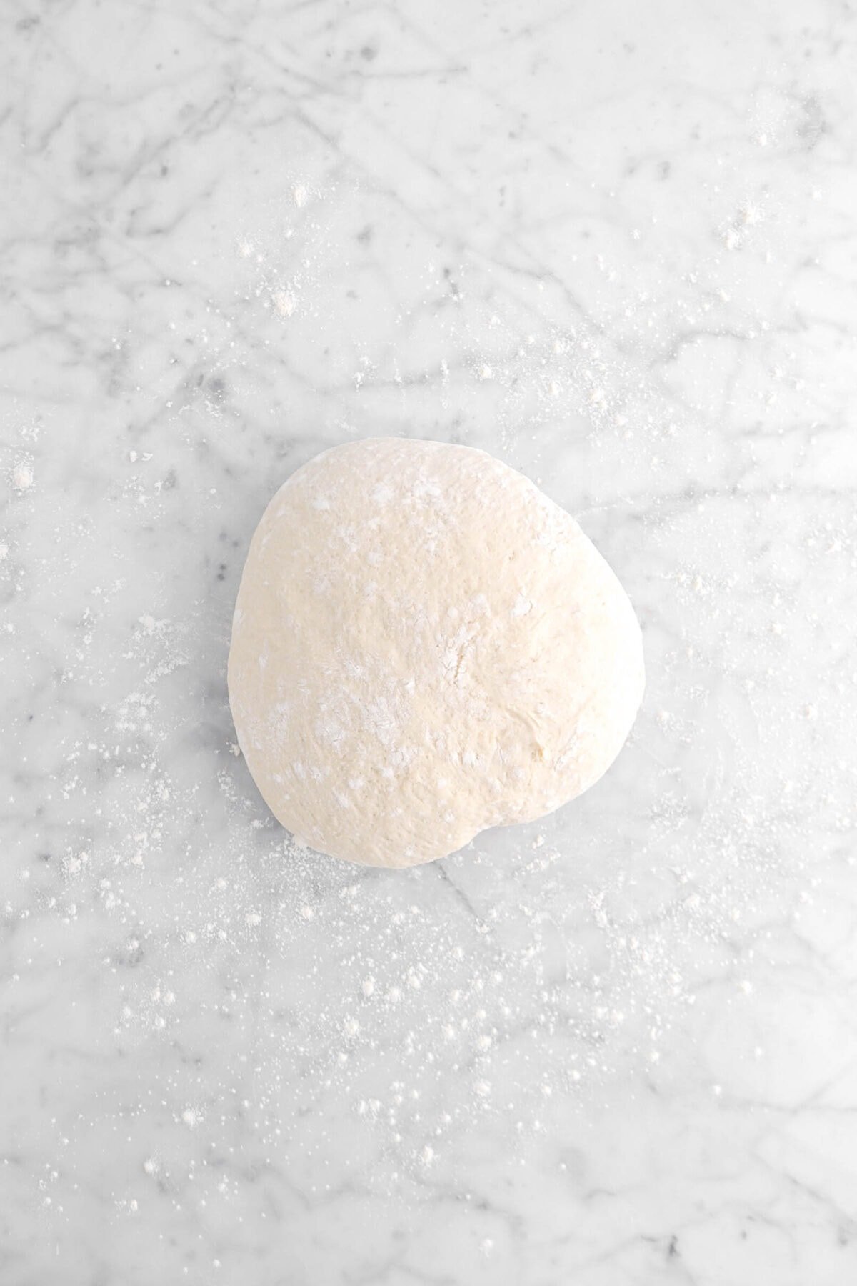 dough boule on floured surface