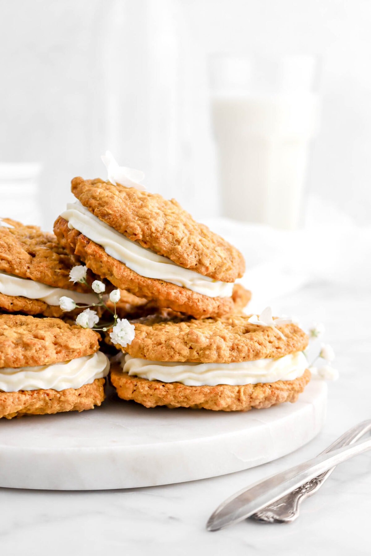 close up of stacked sandwich cookies with white flowers