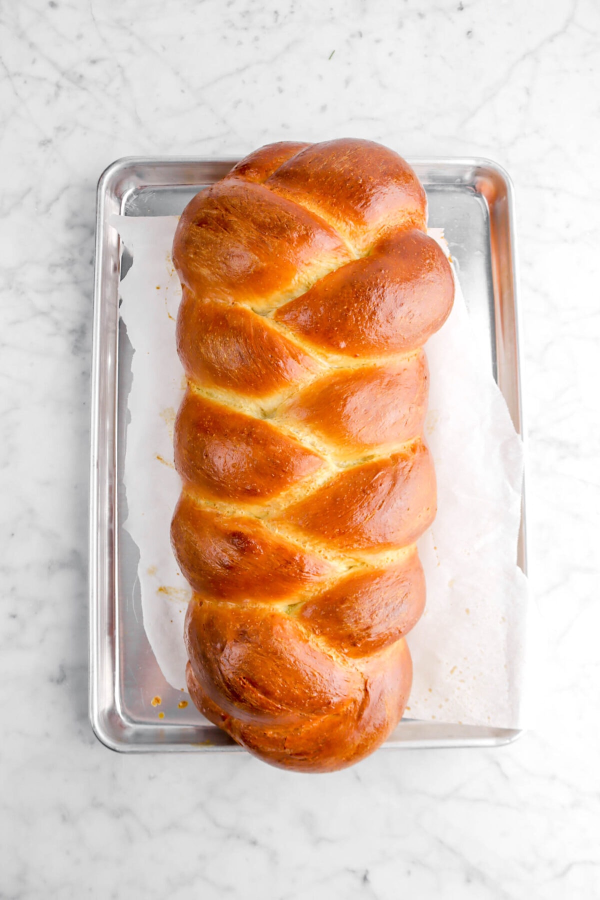 baked challah on lined sheet pan