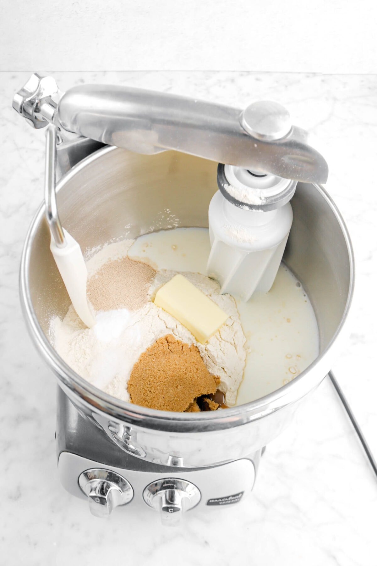 flour, yeast, baking powder, salt, brown sugar, butter, and milk in mixer