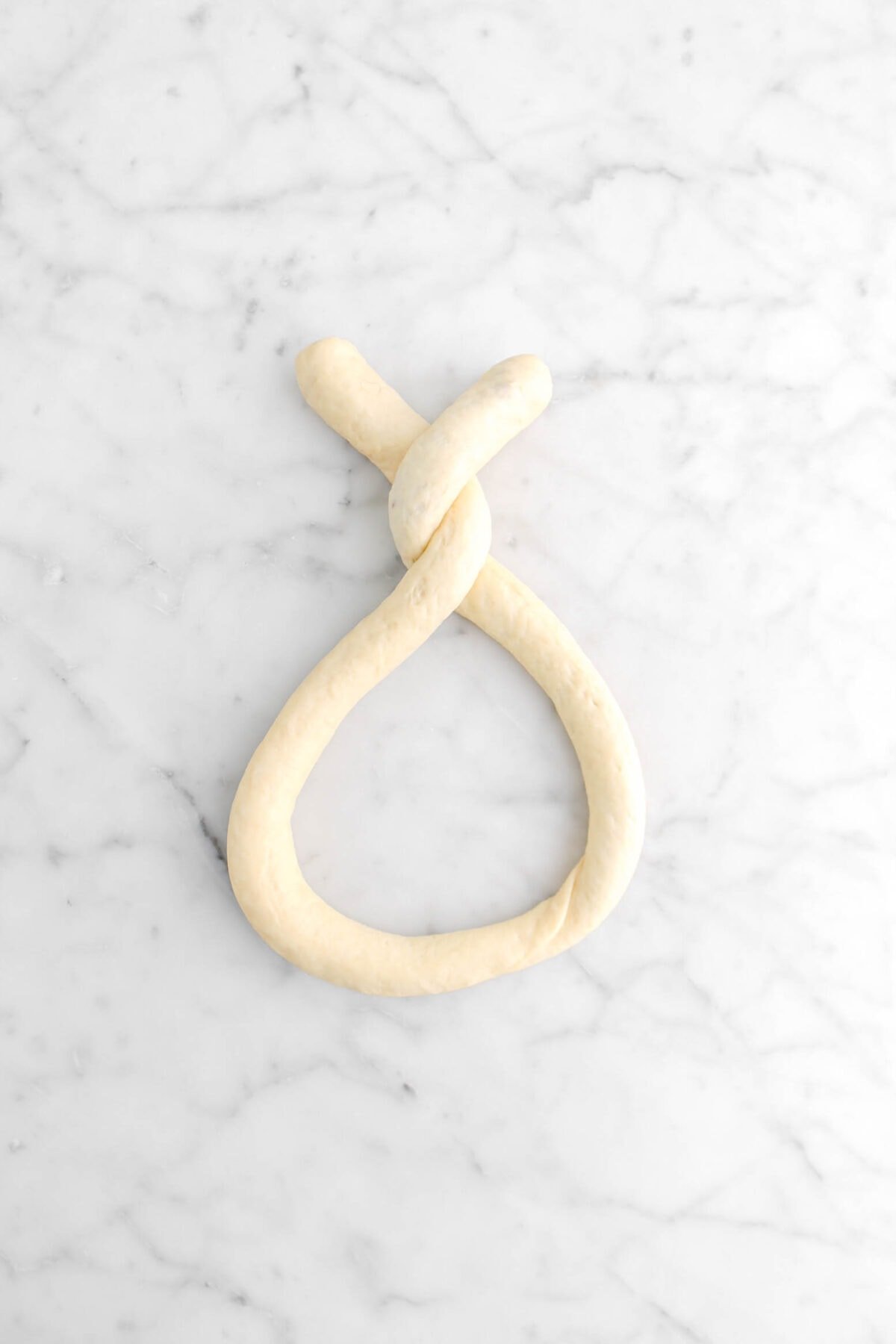 two ends twisted around each other creating a ring shape on marble surface
