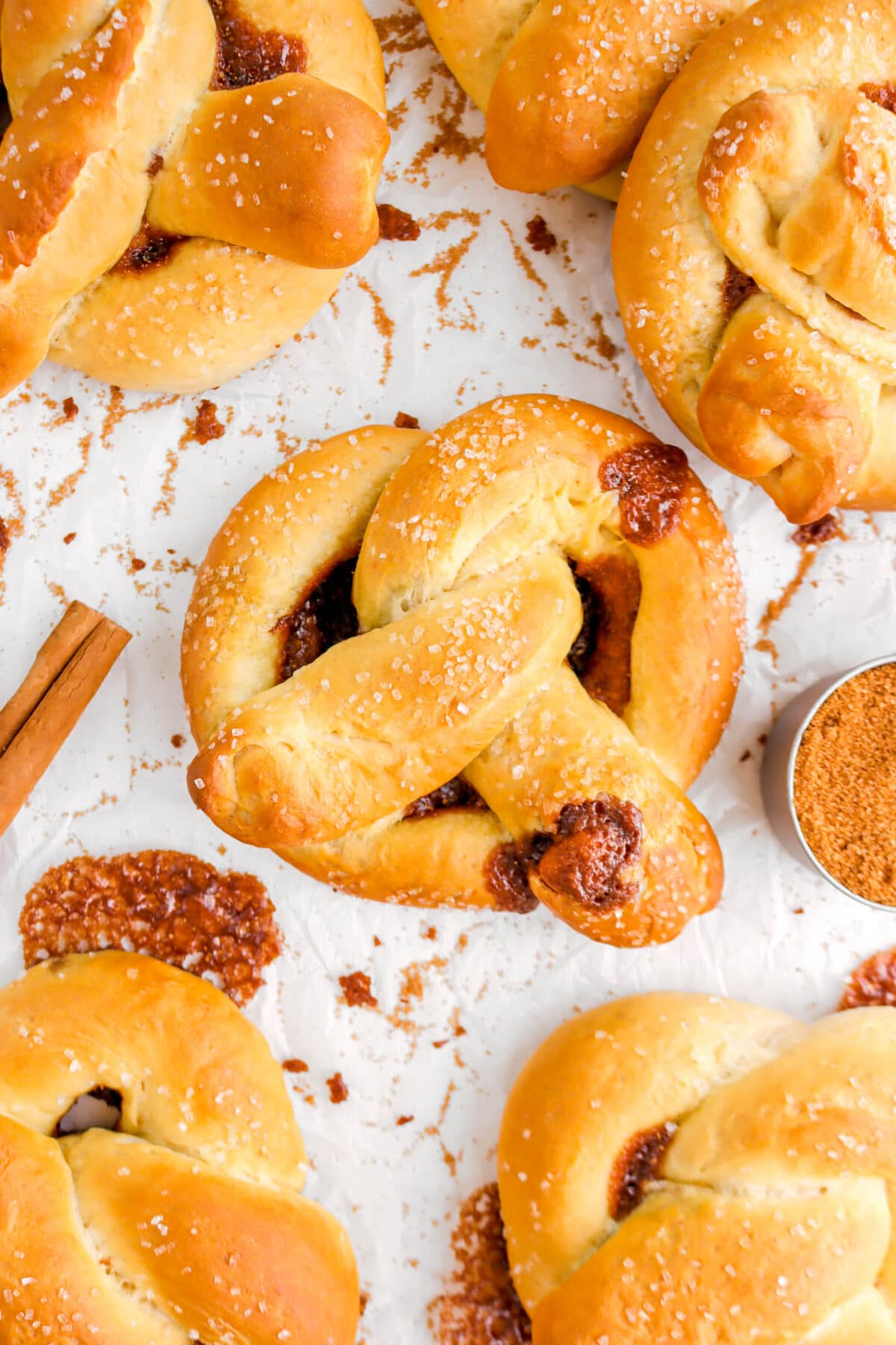 close up of cinnamon sugar pretzel with more pretzels around