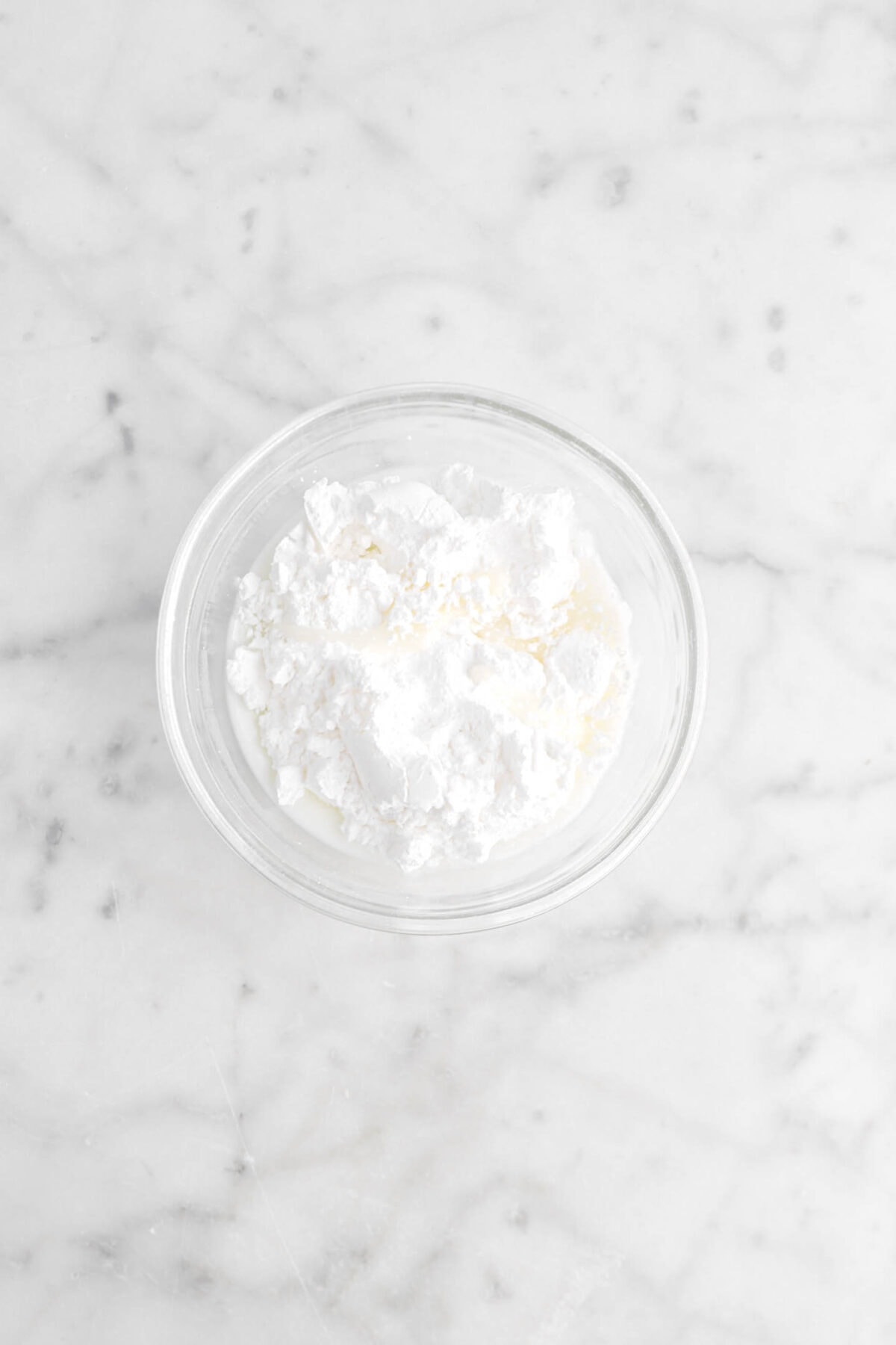 coconut milk and powdered sugar in glass bowl