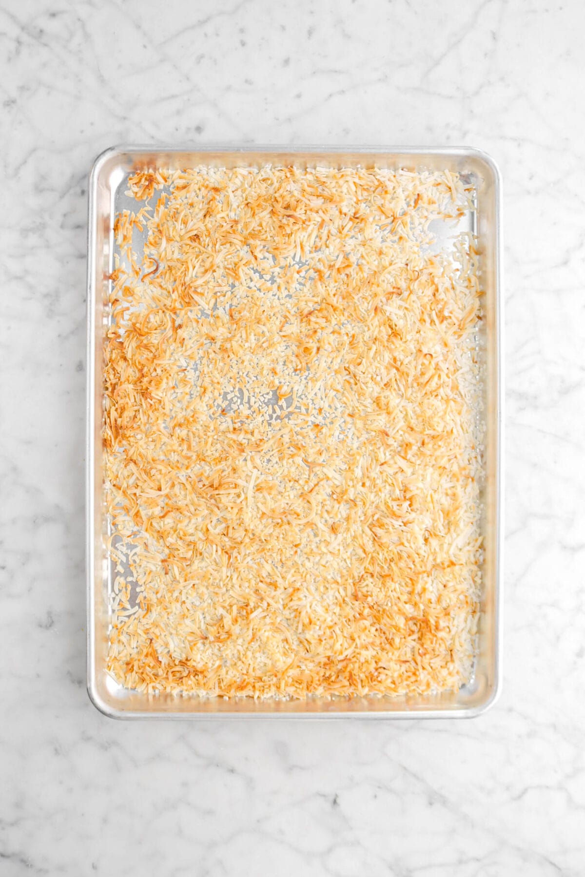 toasted coconut flakes on sheet pan