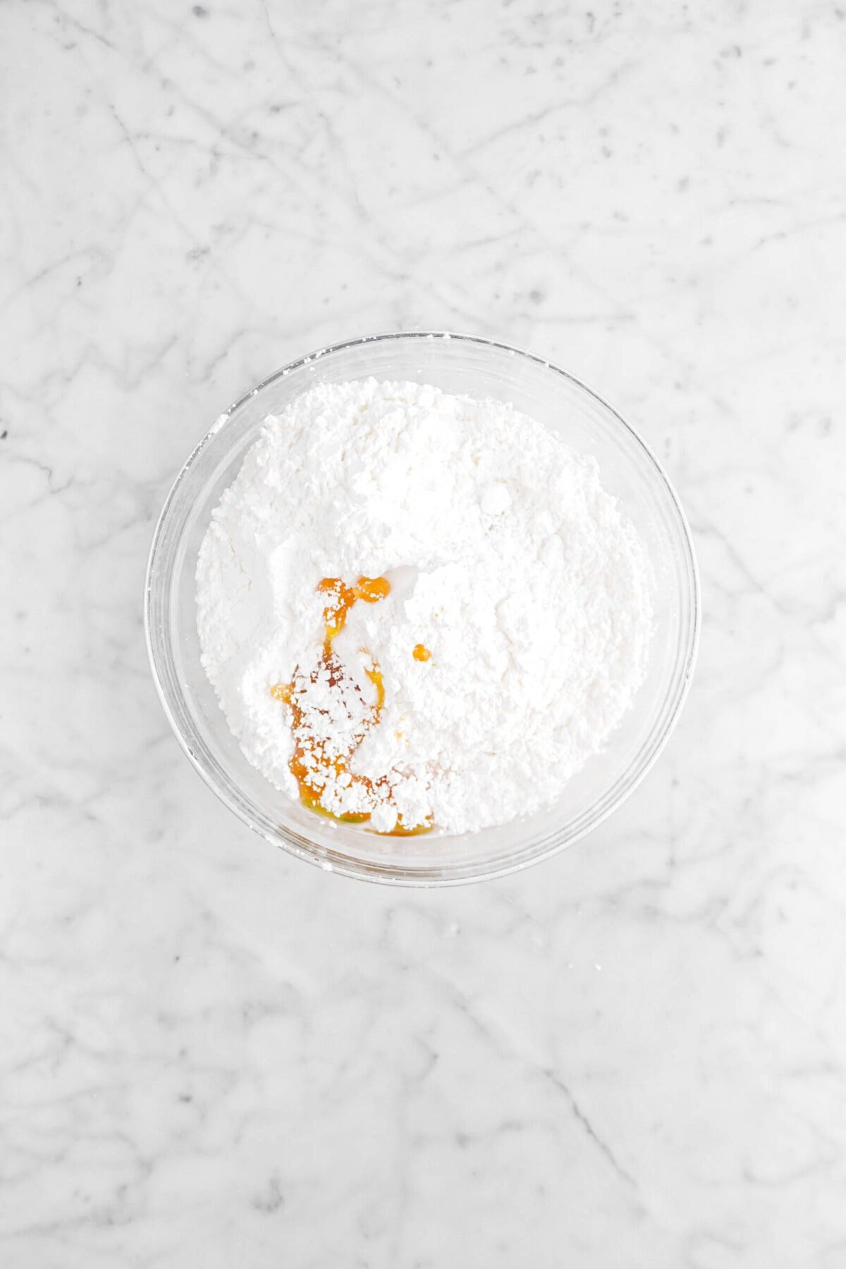 powdered sugar, honey, and milk in glass bowl