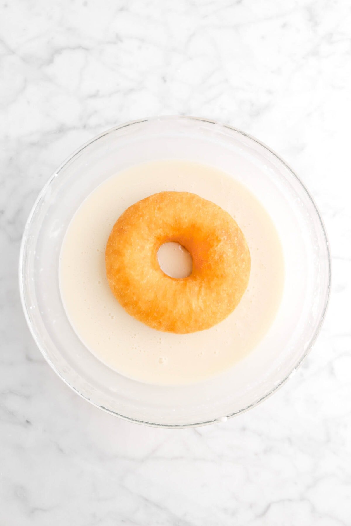 doughnut in glaze in glass bowl