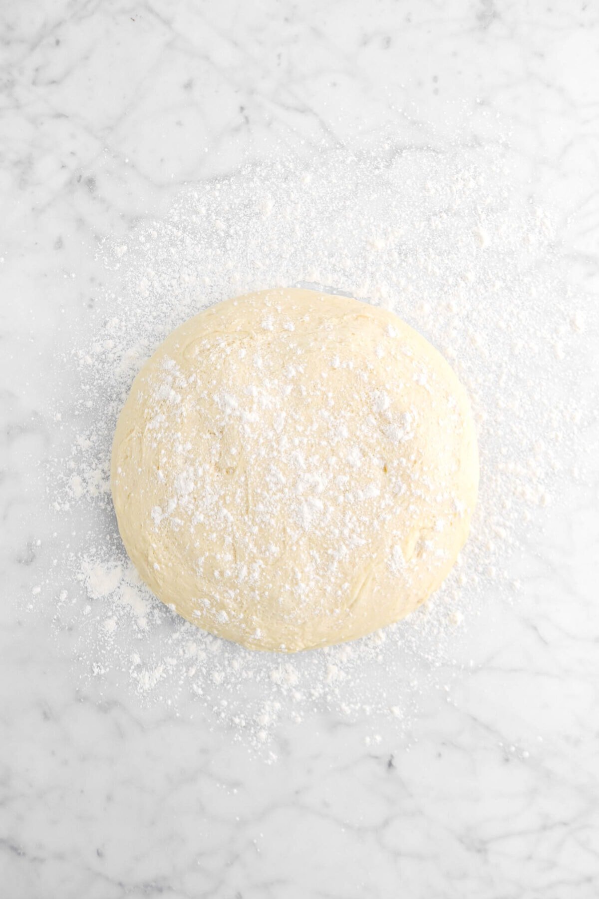 dough on floured marble surface