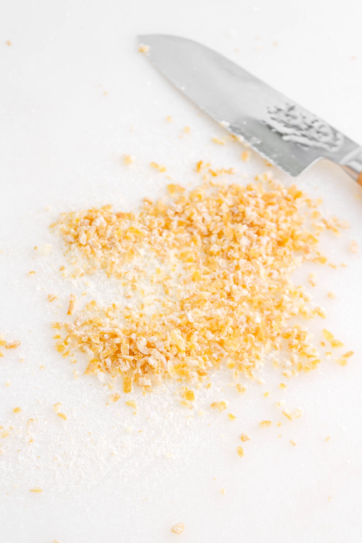 chopped candied lemon peel with knife beside