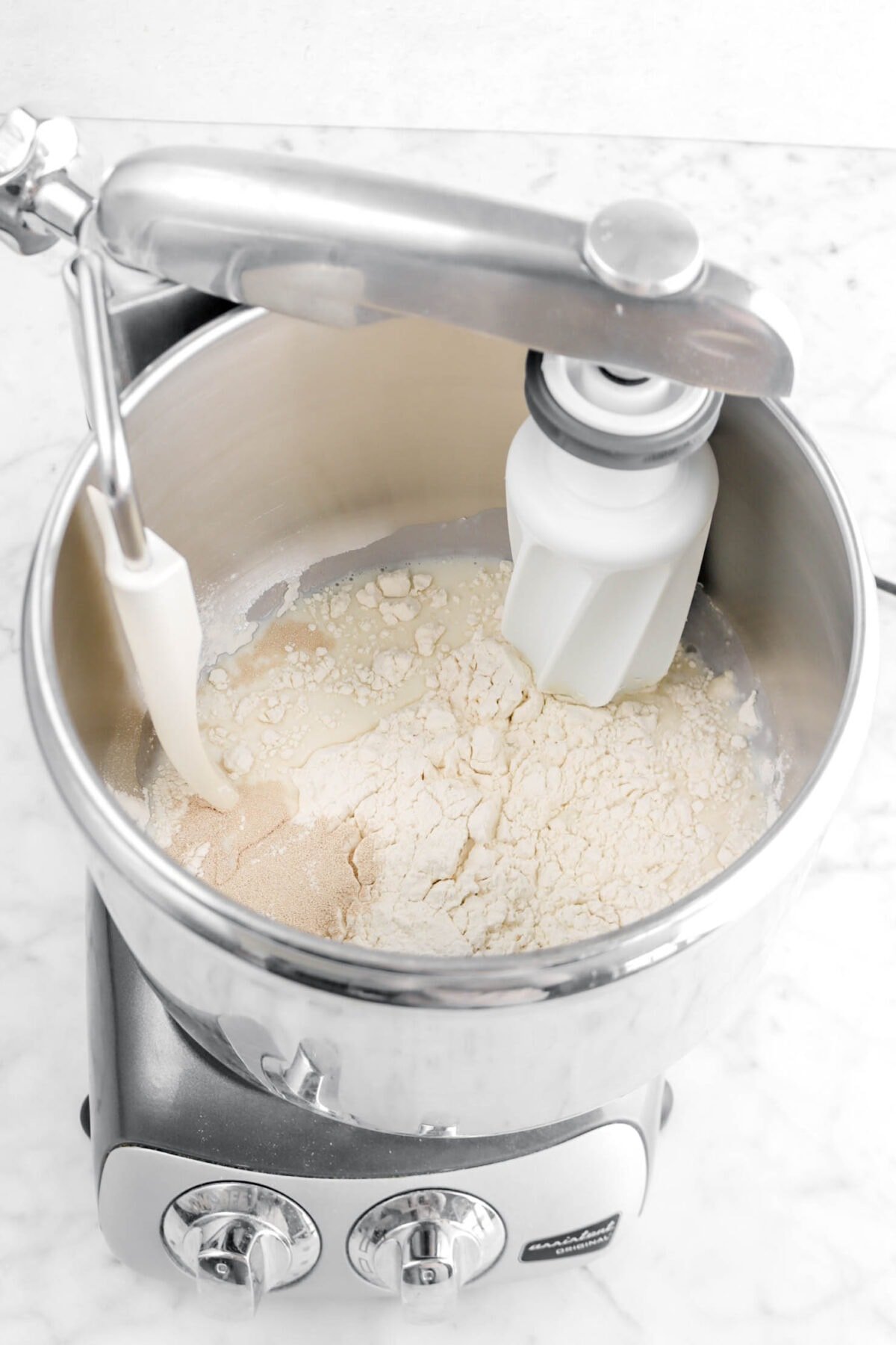 milk, yeast, and flour in mixer