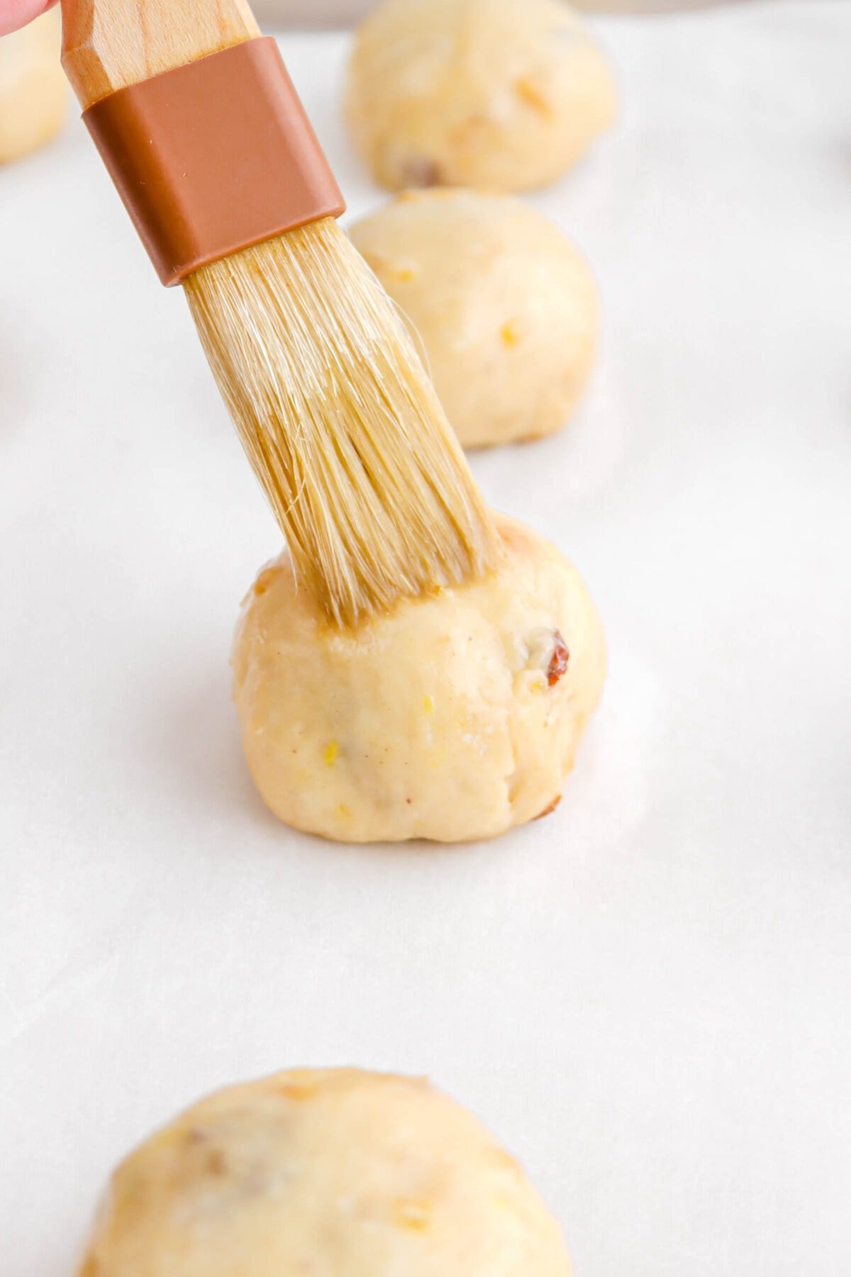 dough ball being brushed with egg wash