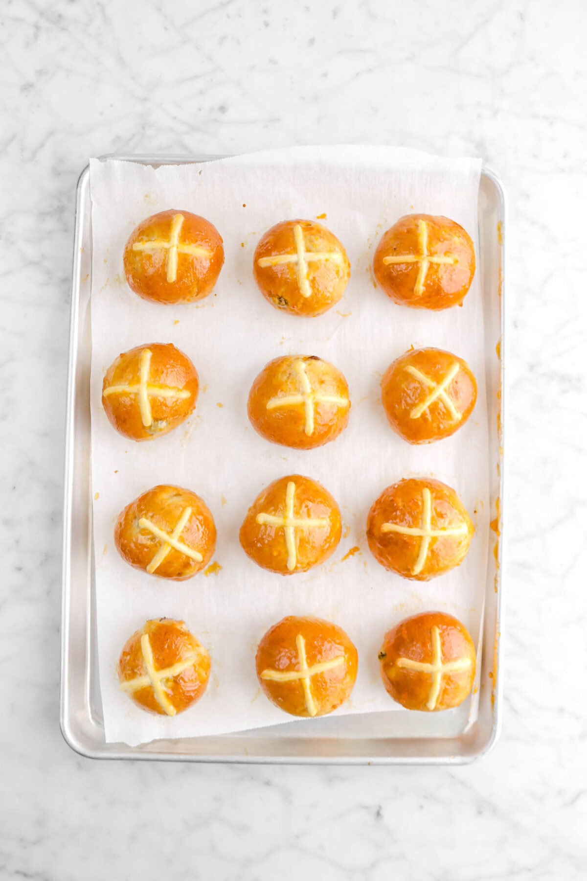 glazed hot cross buns on lined sheet pan