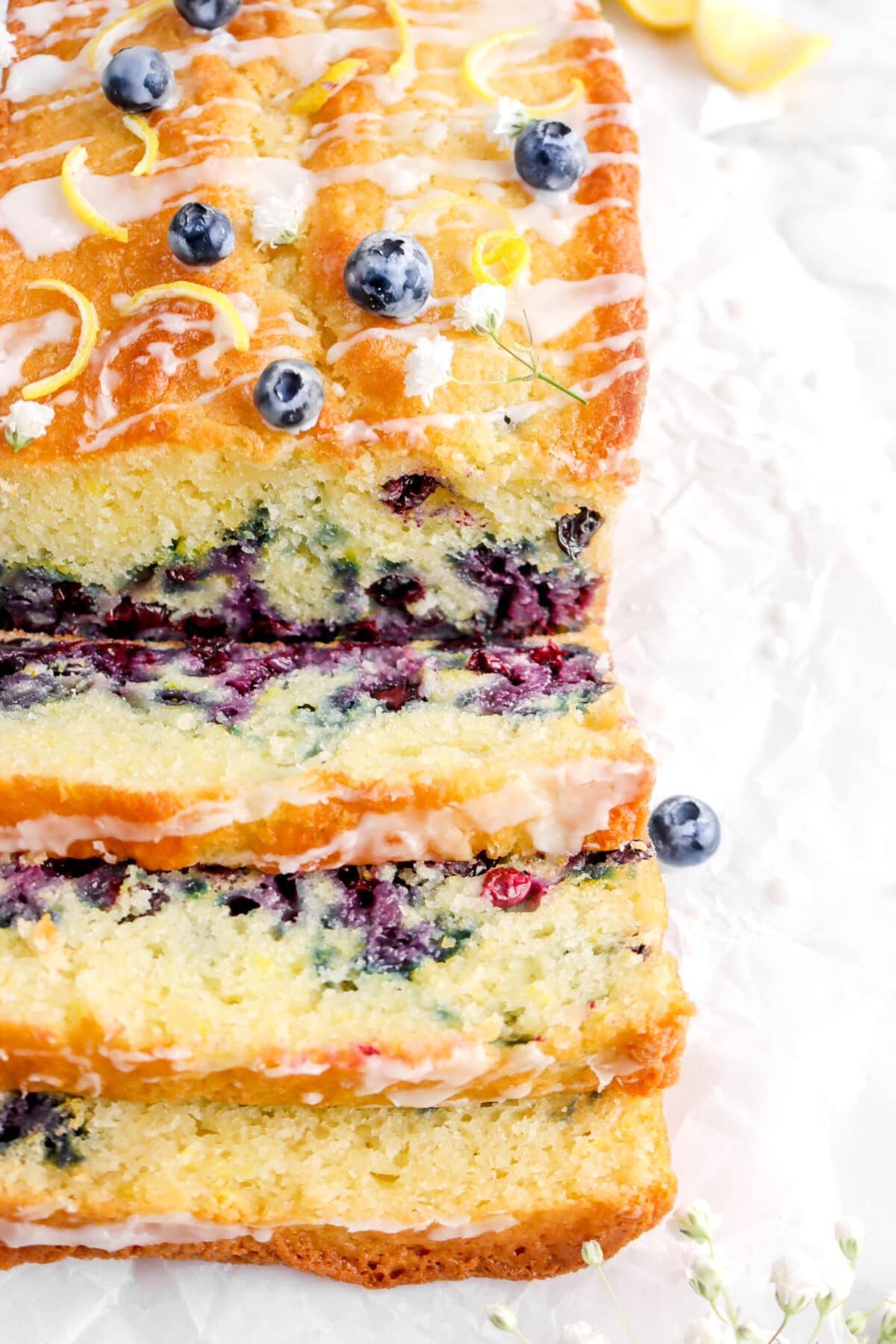 close up angled photo of three slices of lemon blueberry loaf