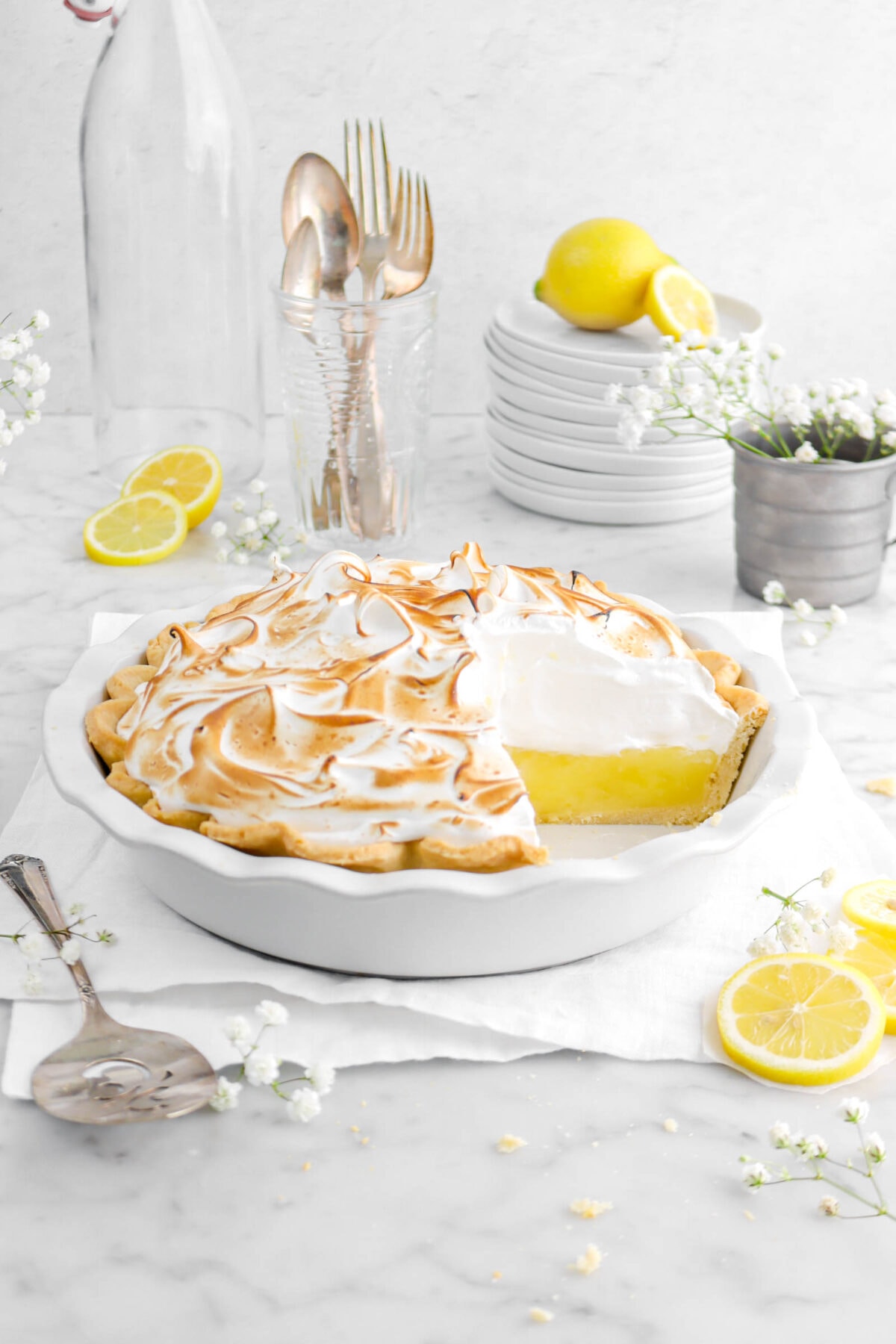 front shot of lemon meringue pie with slice missing