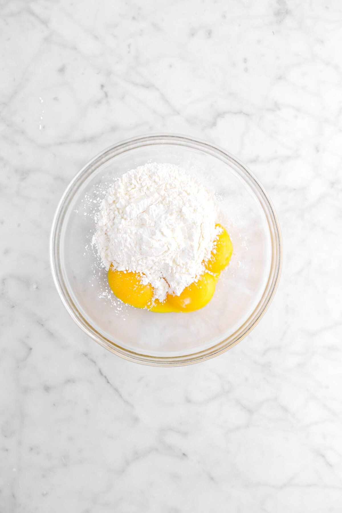 corn starch and egg yolks in glass bowl