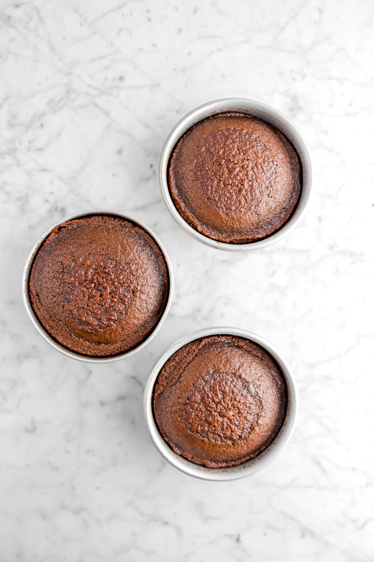 baked chocolate cake in three round cake pans