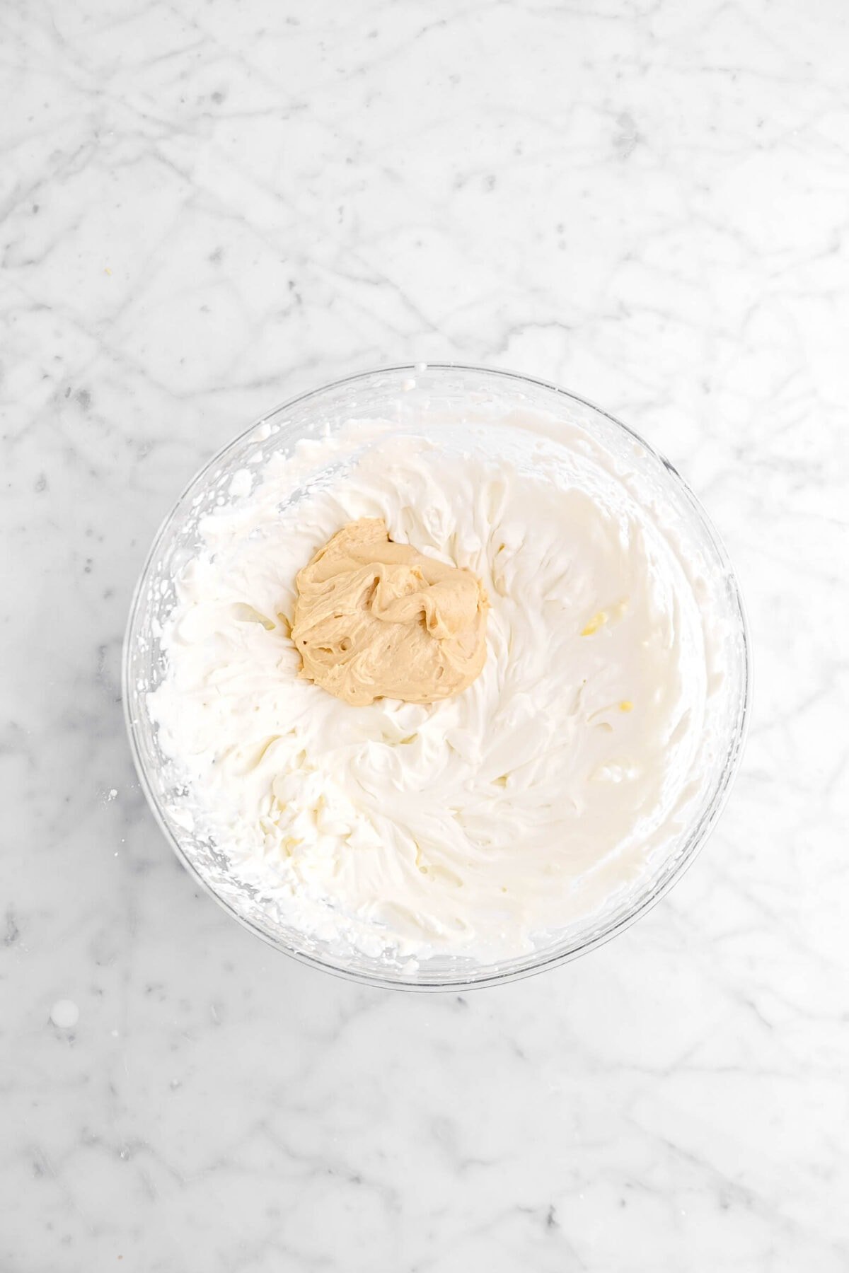 scoop of peanut butter mixture added to chantilly cream
