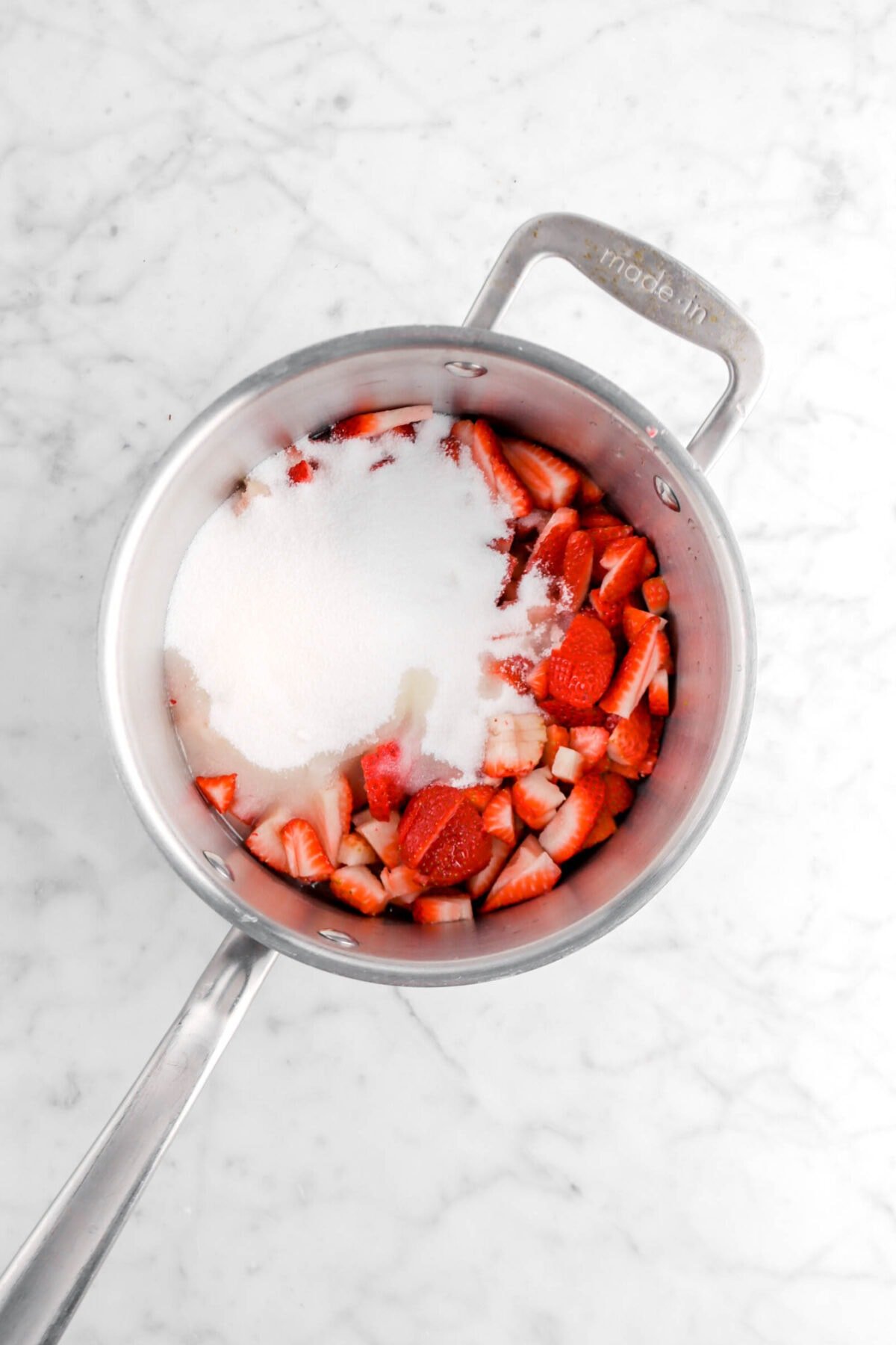 sugar, lemon juice, and chopped strawberries in a pot