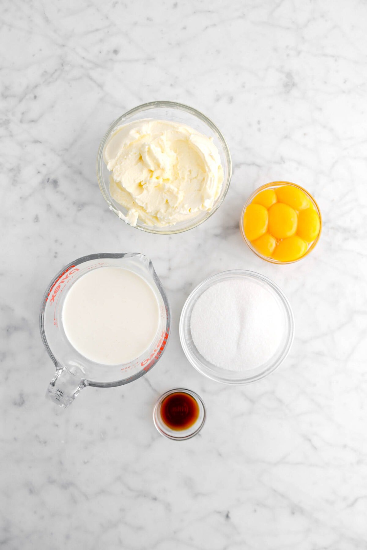 mascarpone, egg yolks, heavy cream, sugar, and vanilla on marble surface