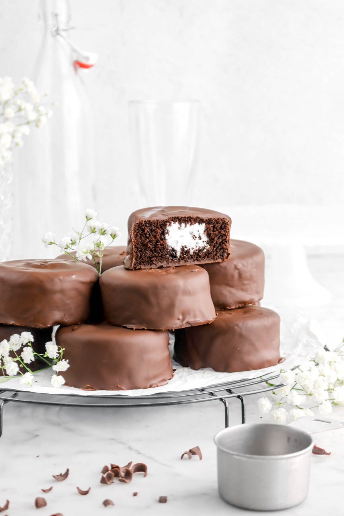 mini chocolate coated cakes with one cut in half exposing marshmallow center