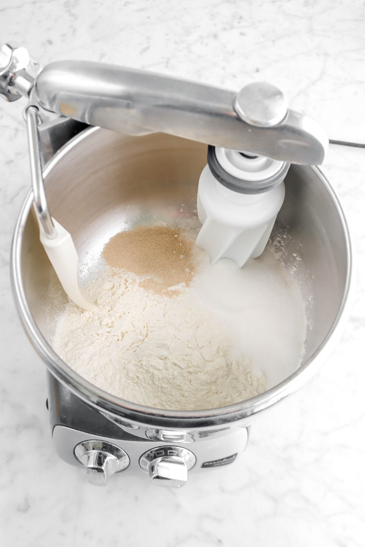 flour, sugar, salt, and yeast in stand mixer