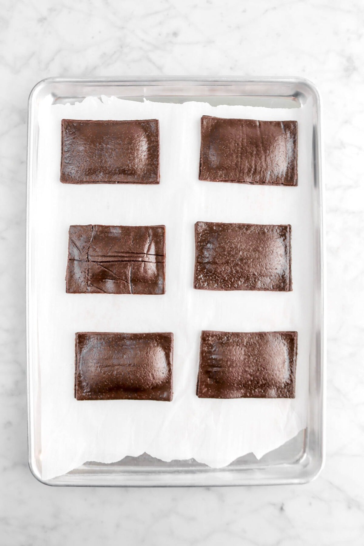 individual chocolate dough rectangles laid over ganache