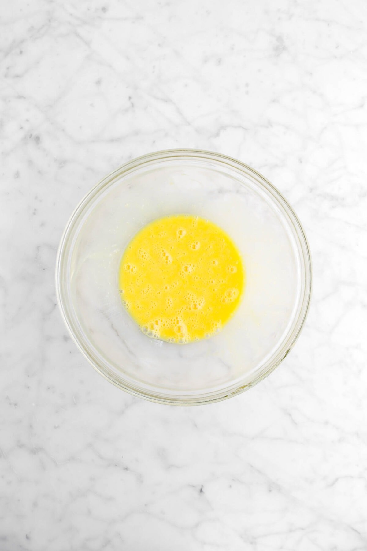 whisked eggs in glass bowl