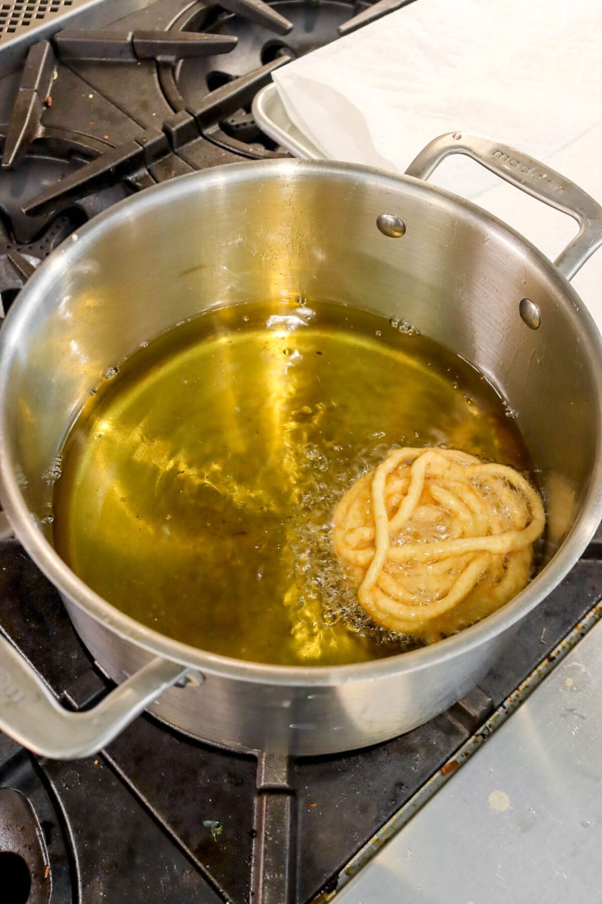 funnel cake being fried in large pot