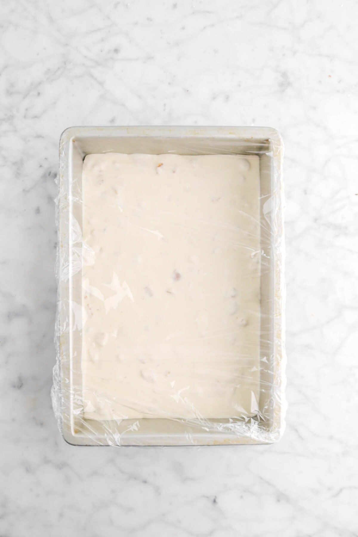 ice cream in sheet pan covered with plastic wrap