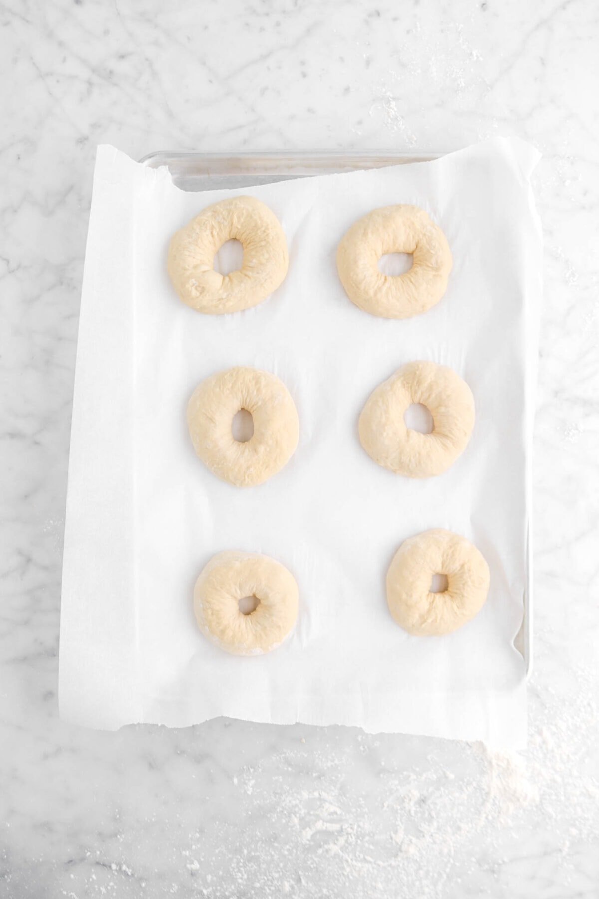 six bagels on lined sheet pan