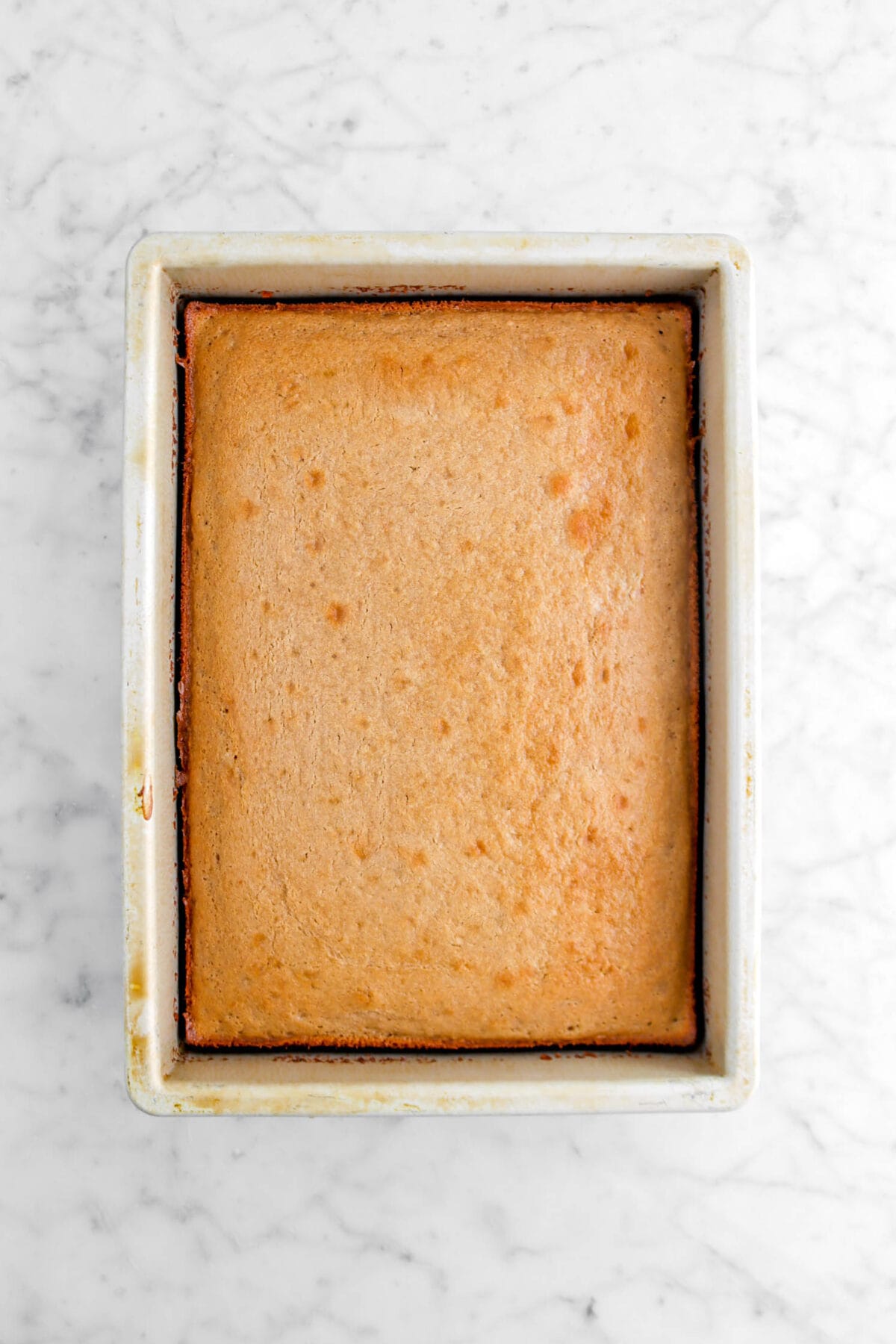 baked sheet cake on marble surface in rectangular pan