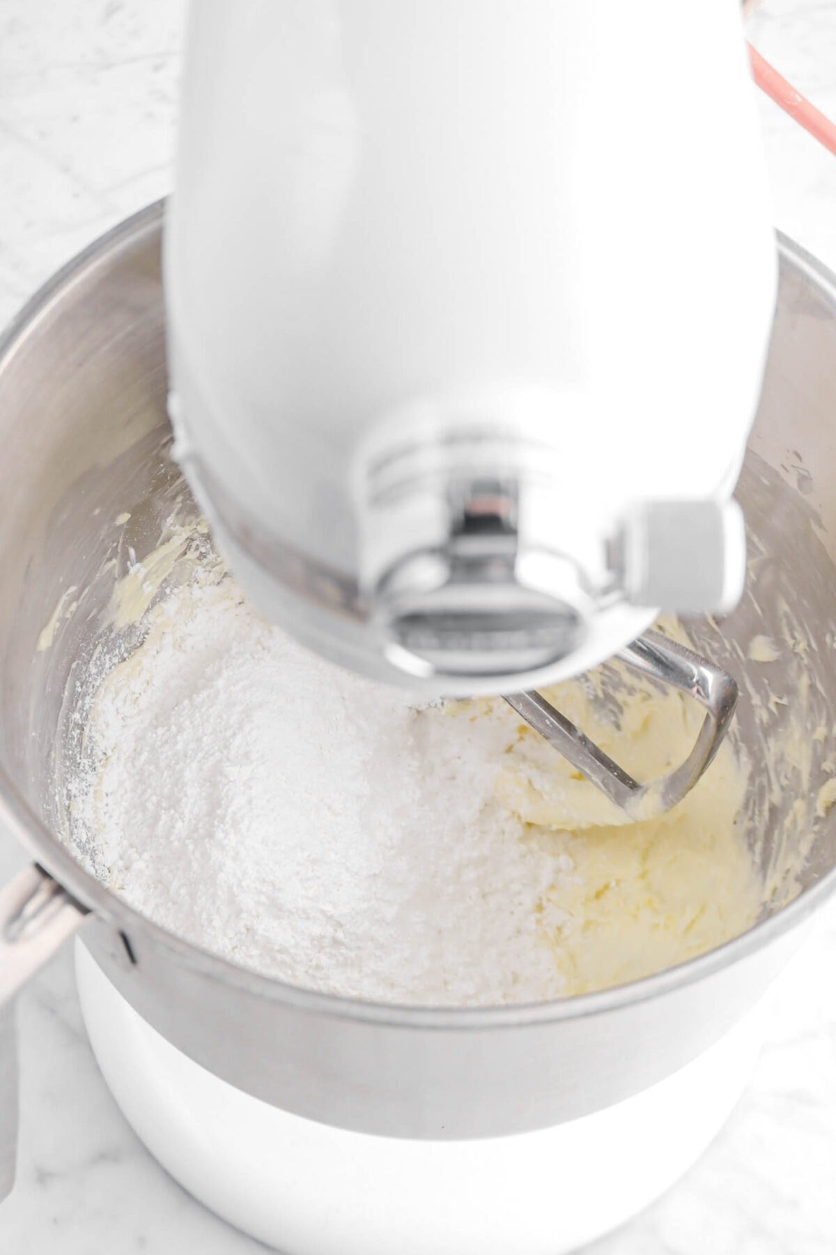 powdered sugar and creamed butter in stand mixer