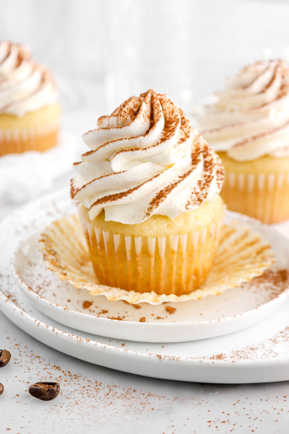 close up of tiramisu cupcake on white plates on a cupcake paper