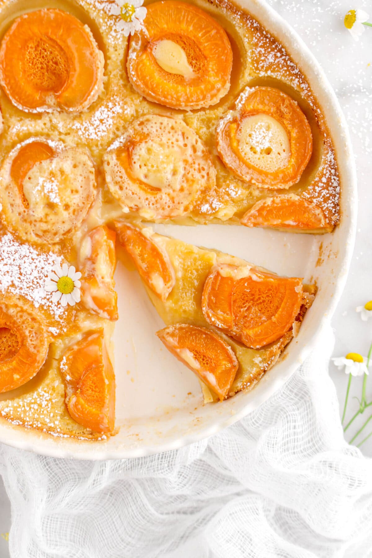 close up overhead shot of slice of apricot clafoutis
