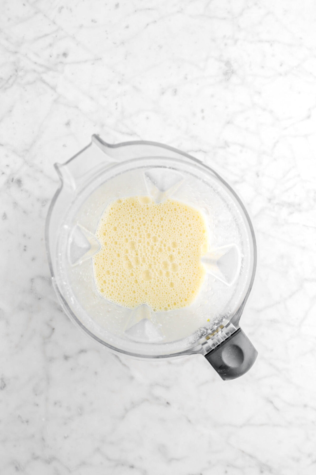 clafoutis batter in blender on marble surface