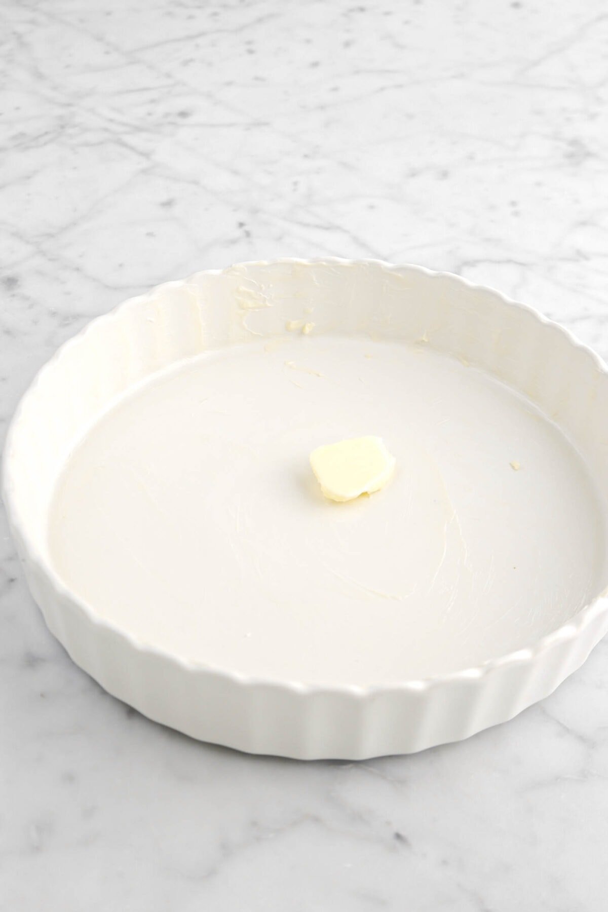 pad of butter in pie plate