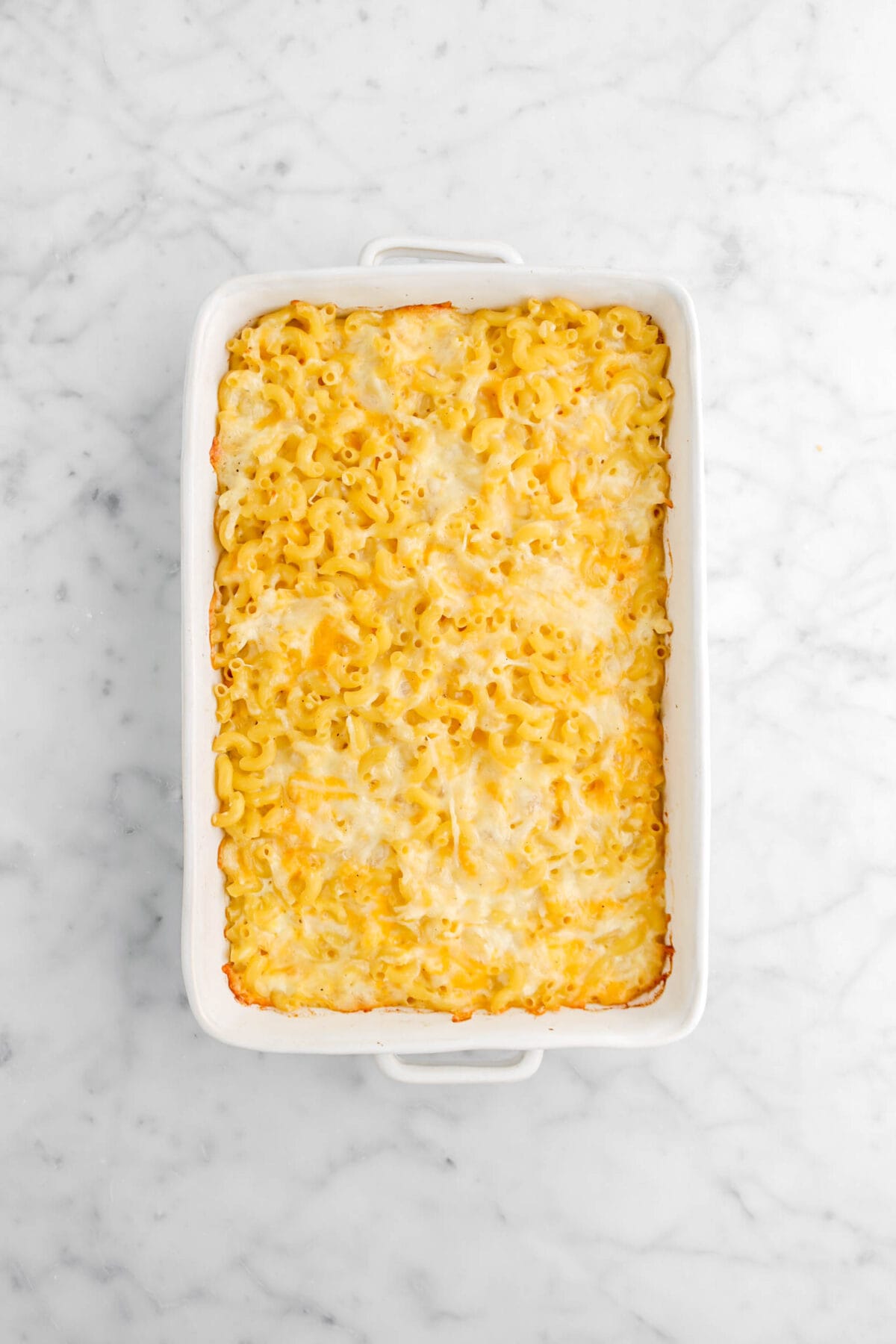 baked mac and cheese in white casserole on marble surface