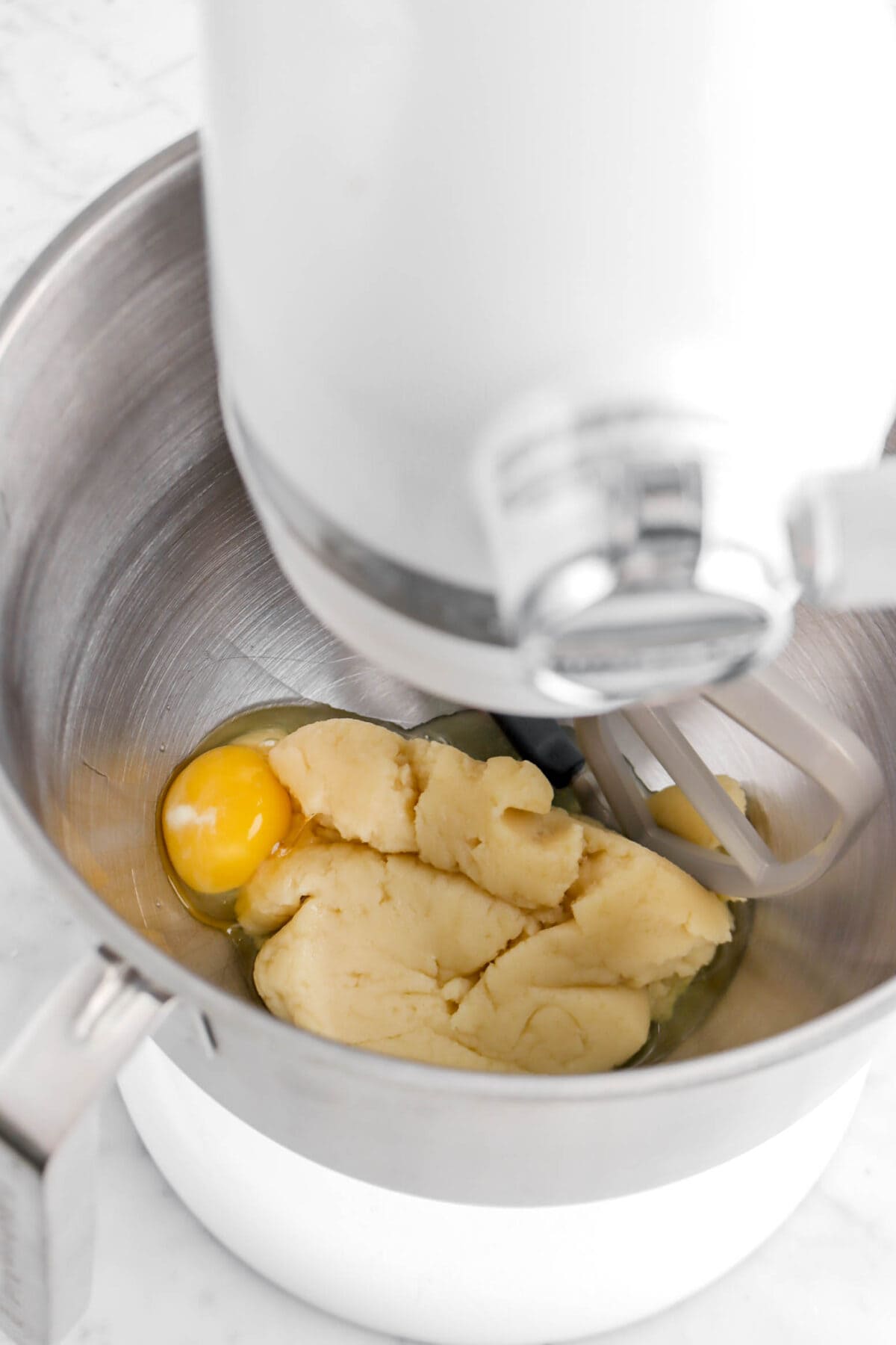 egg and dough in stand mixer