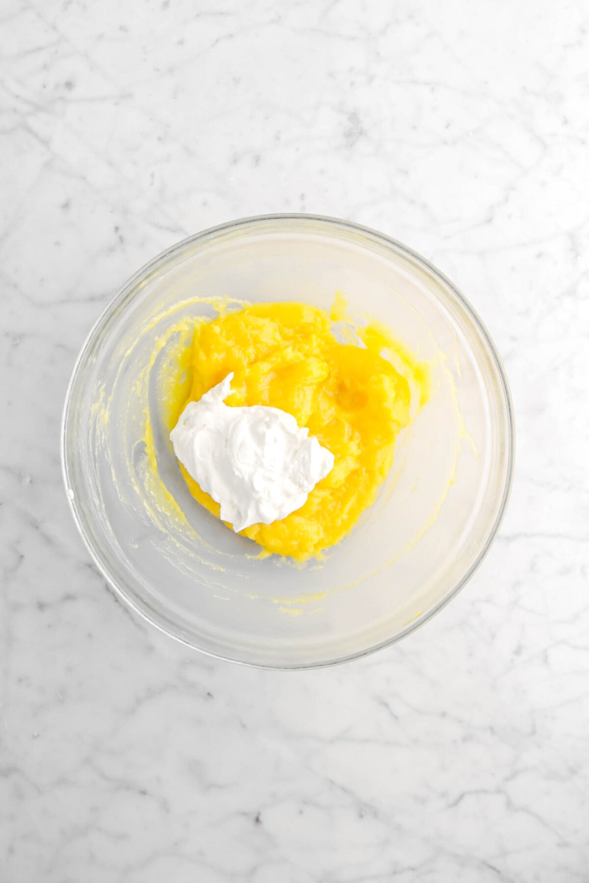 whipped cream and lemon curd in glass bowl