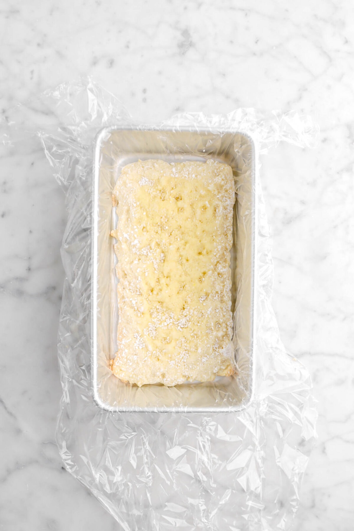 cake layer in plastic wrap lined loaf pan