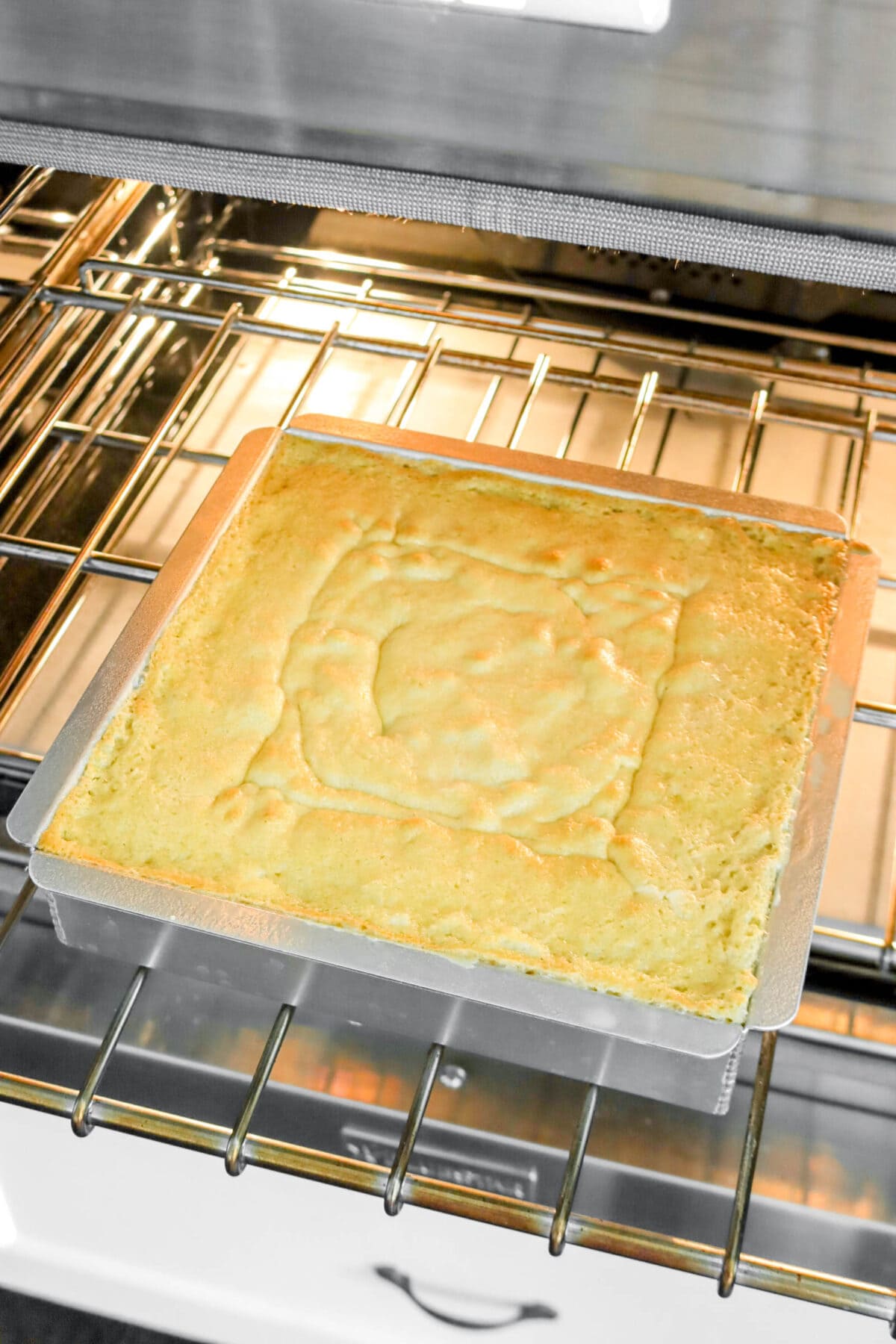 partially baked cake on oven rack